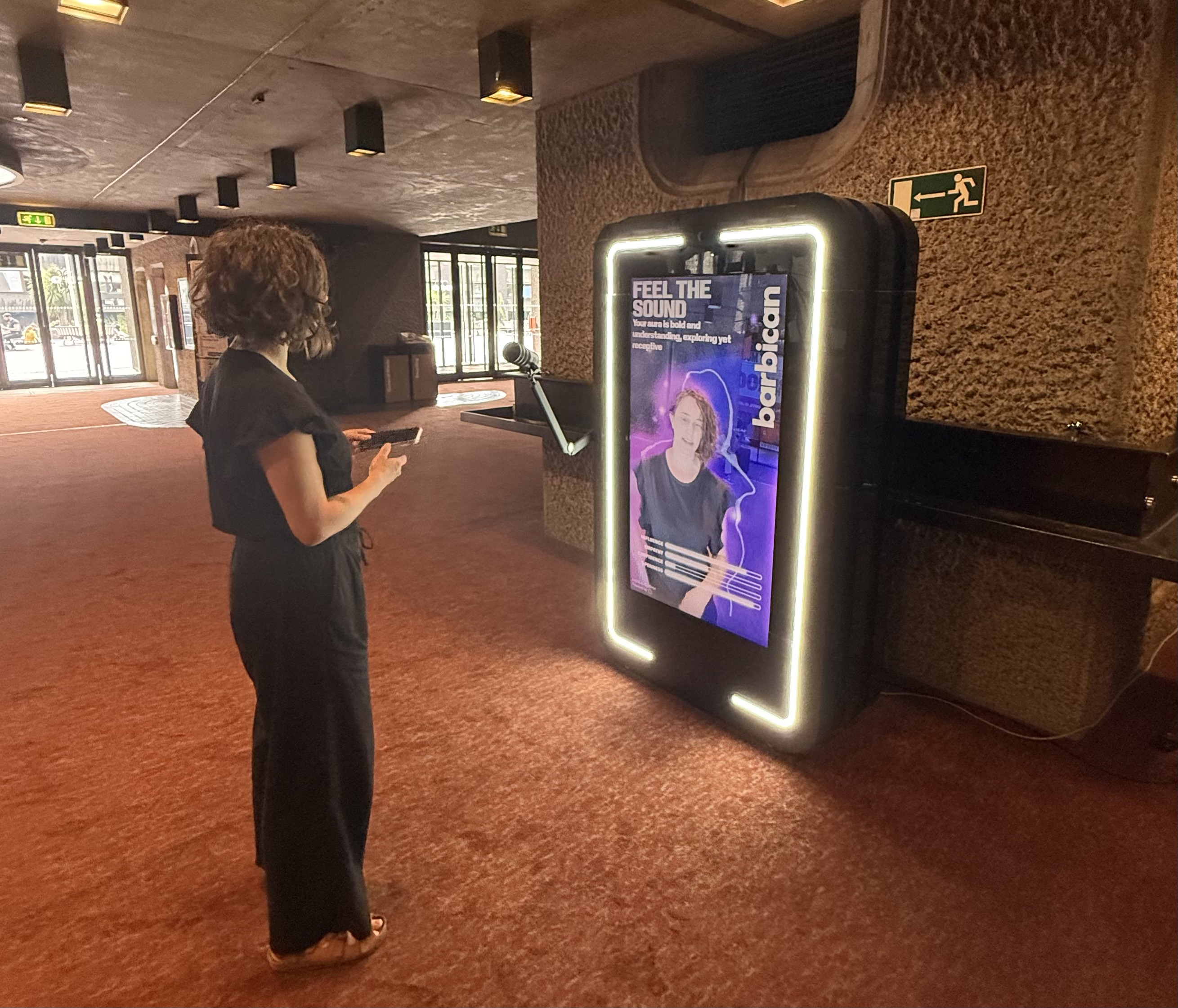 Visitor using the AR Mirror in the Barbican foyer